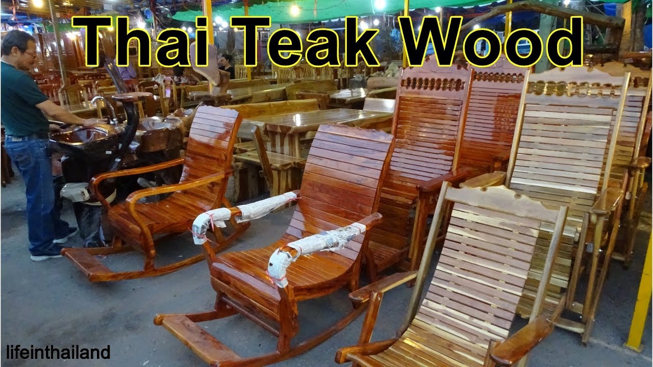 Beautiful handmade teak wood furniture sold on the side of a busy road in Thailand.