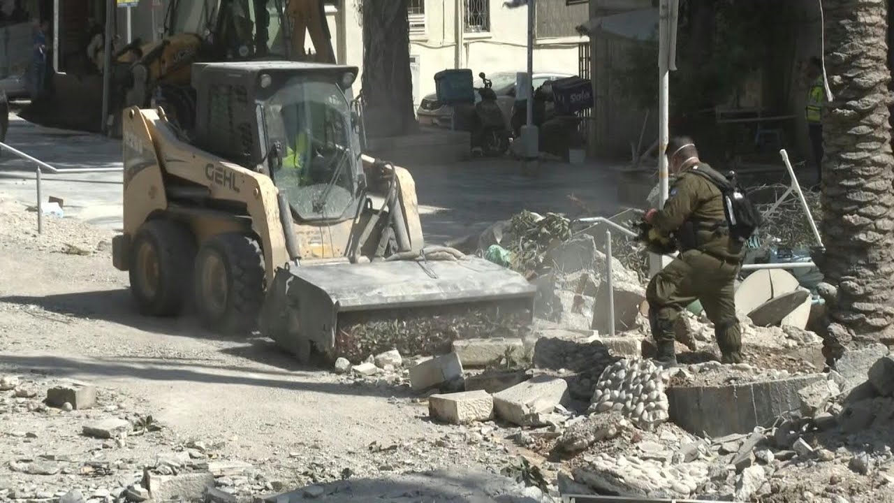 Israeli first responders clear rubble in Haifa after Iran missile attack | AFP