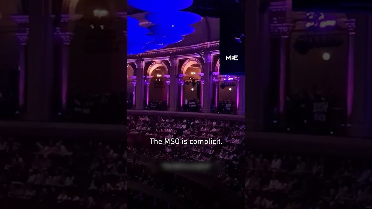 Activists chant against the Melbourne Symphony Orchestra, disrupting the BBC Proms