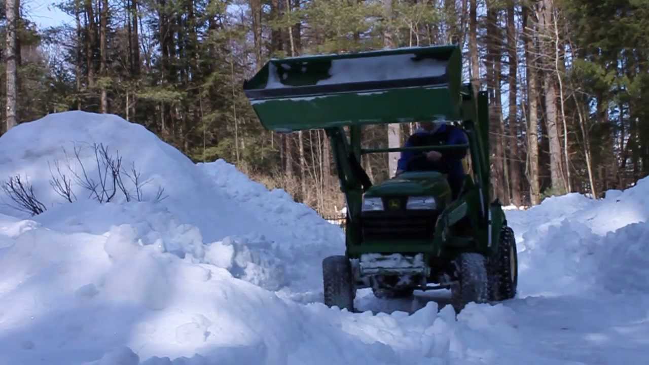 John Deere X585 w/ 45 loader moving 24in of packed snow