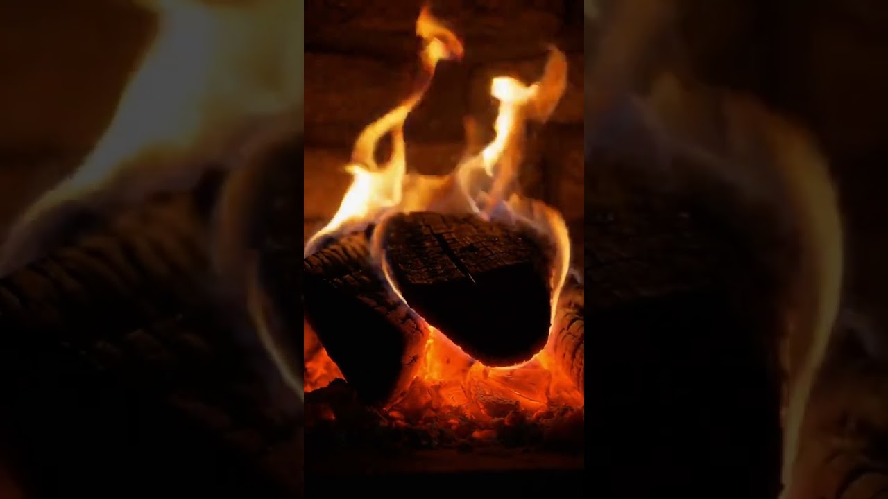 Cozy stone fireplace with glowing embers and gentle night flames 🔥