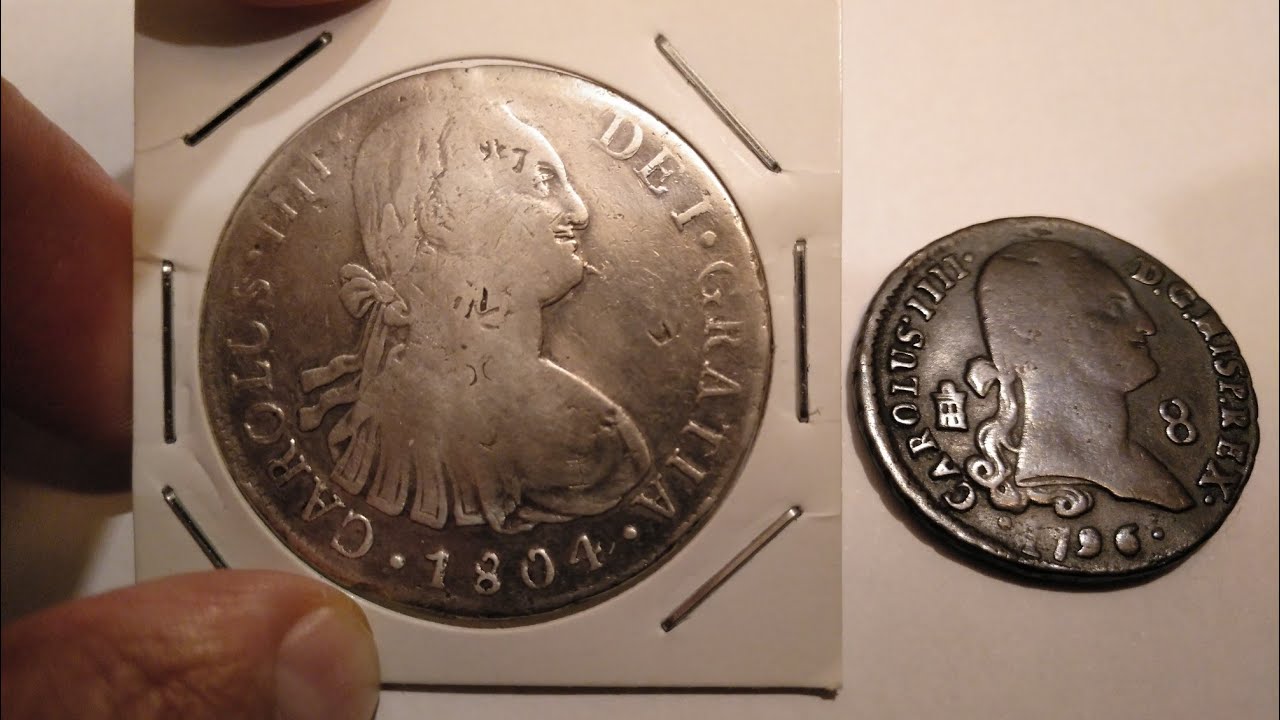 Monedas de Carlos IV. 8 Reales resellos chinos (1804, Lima), 8 Maravedis (1796, Segovia).