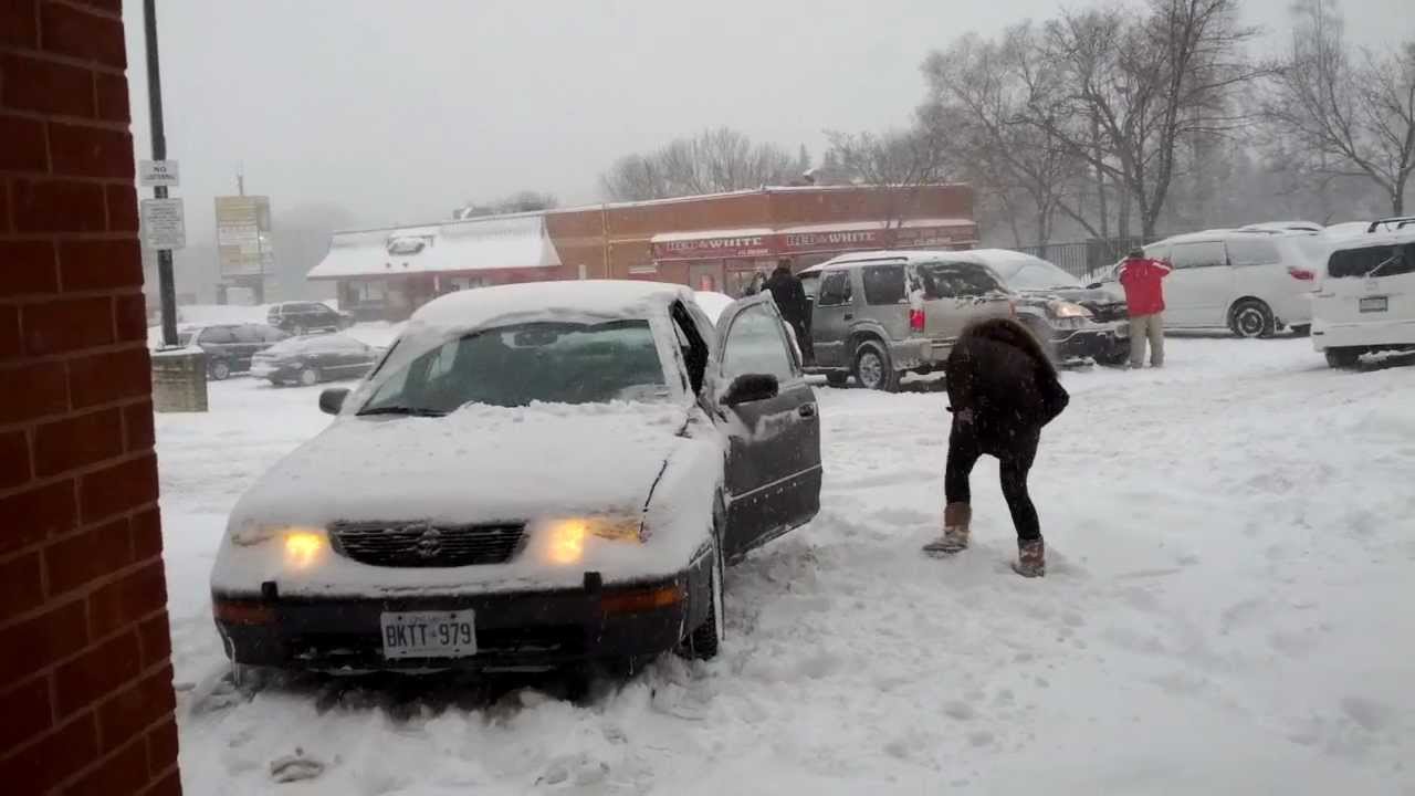 Car stuck in snow, it needs winter tires, sliding