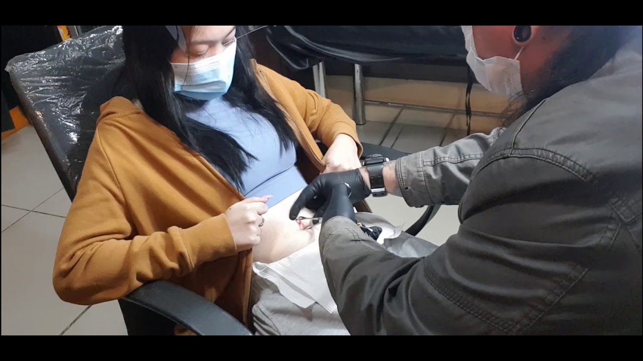 Beautiful young lady getting her bellybutton pierced  IMMORTAL TATTOO Manila Philippines