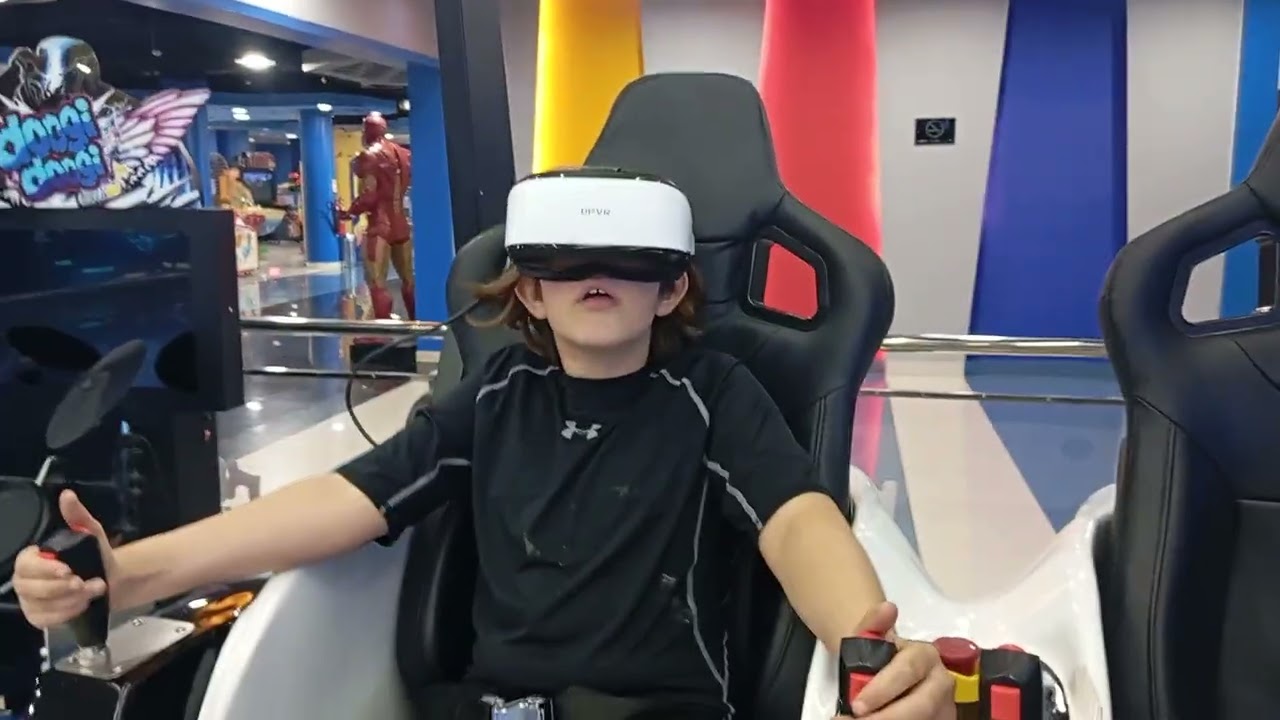 Sam tries the VR Jurassic World game at Menara Mall in Marrakesh 