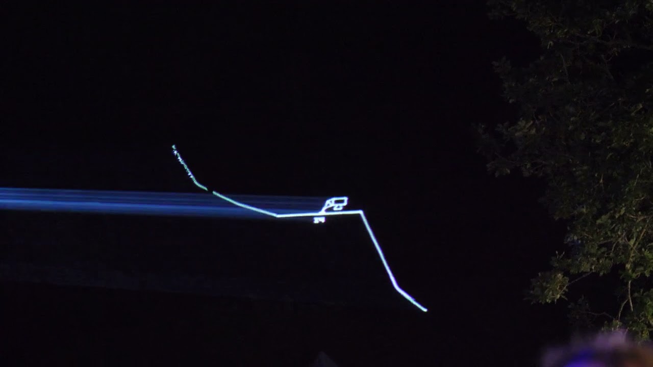 Projecting lasers on a hillside at EMF2024