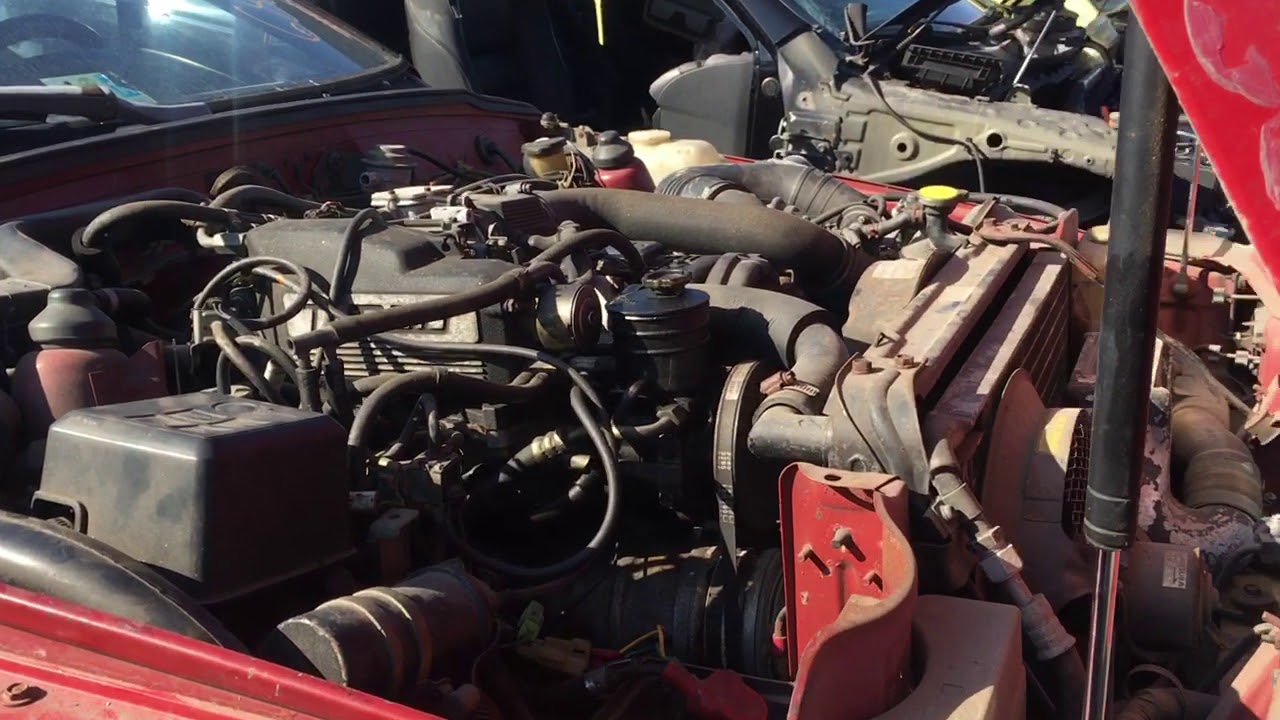 At the junkyard looking at a 1988 Isuzu impulse turbo very rare car!!!