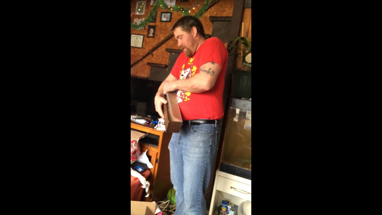 Step-dad opens his Christmas present.