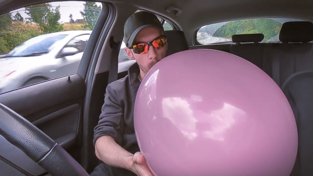 Blowing up and bursting a big pink balloon