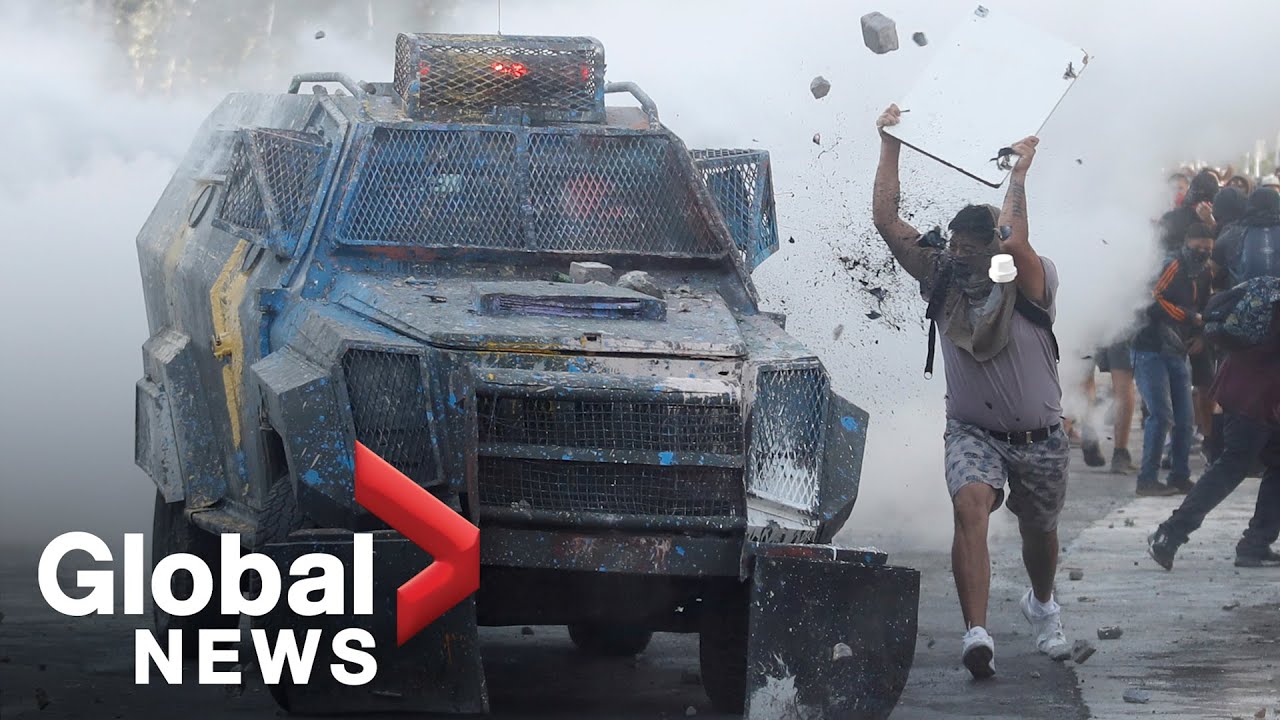 Chile protests: Demonstrators clash with security force vehicles in Santiago