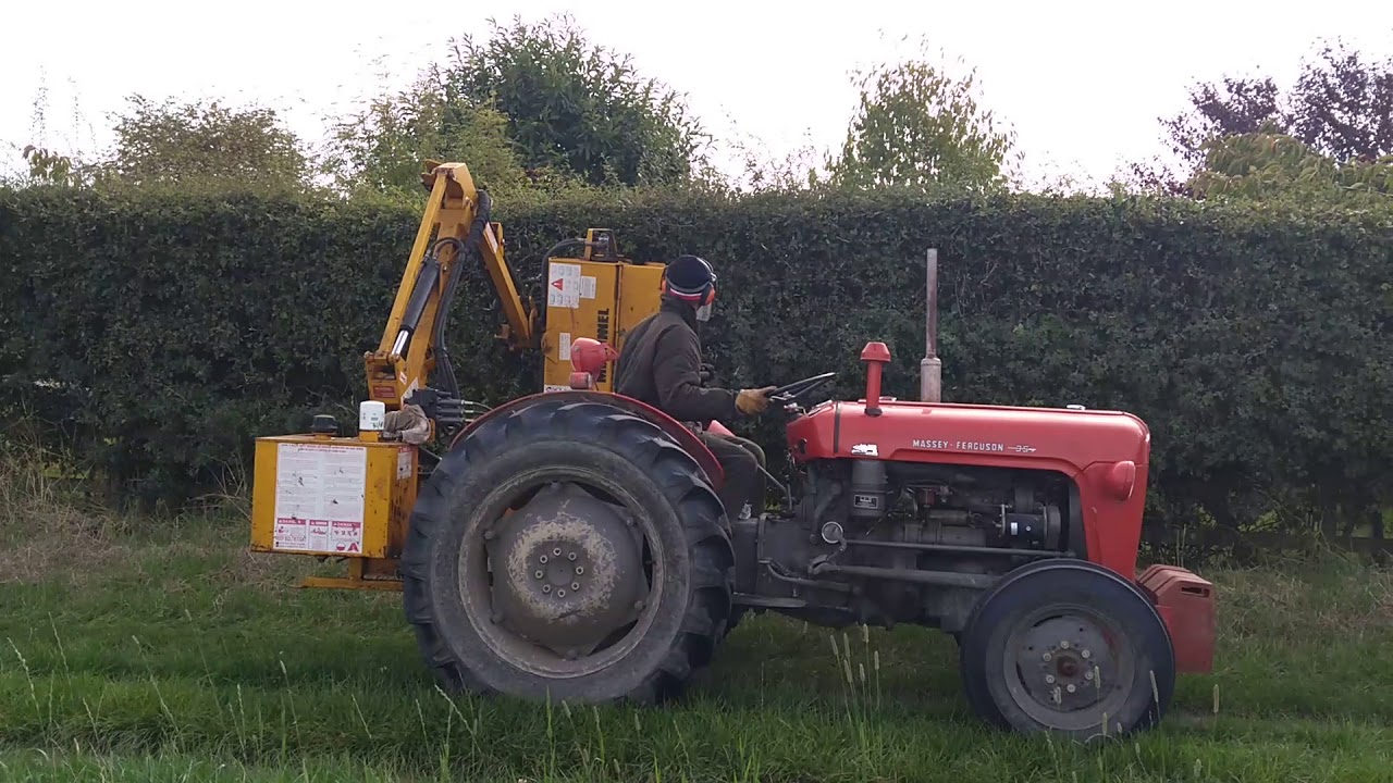 Massey Ferguson 35 MF with McCONNEL PA90 hedge cutter flail cutting UK