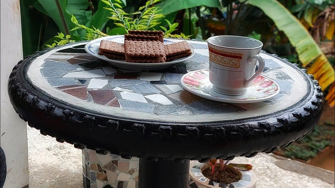 Making a coffee table out of old tires and tiles is a simple task.