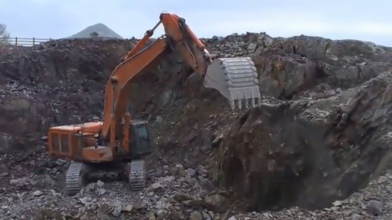 Hitachi 650 excavator loading dumpers on a road construction site #1