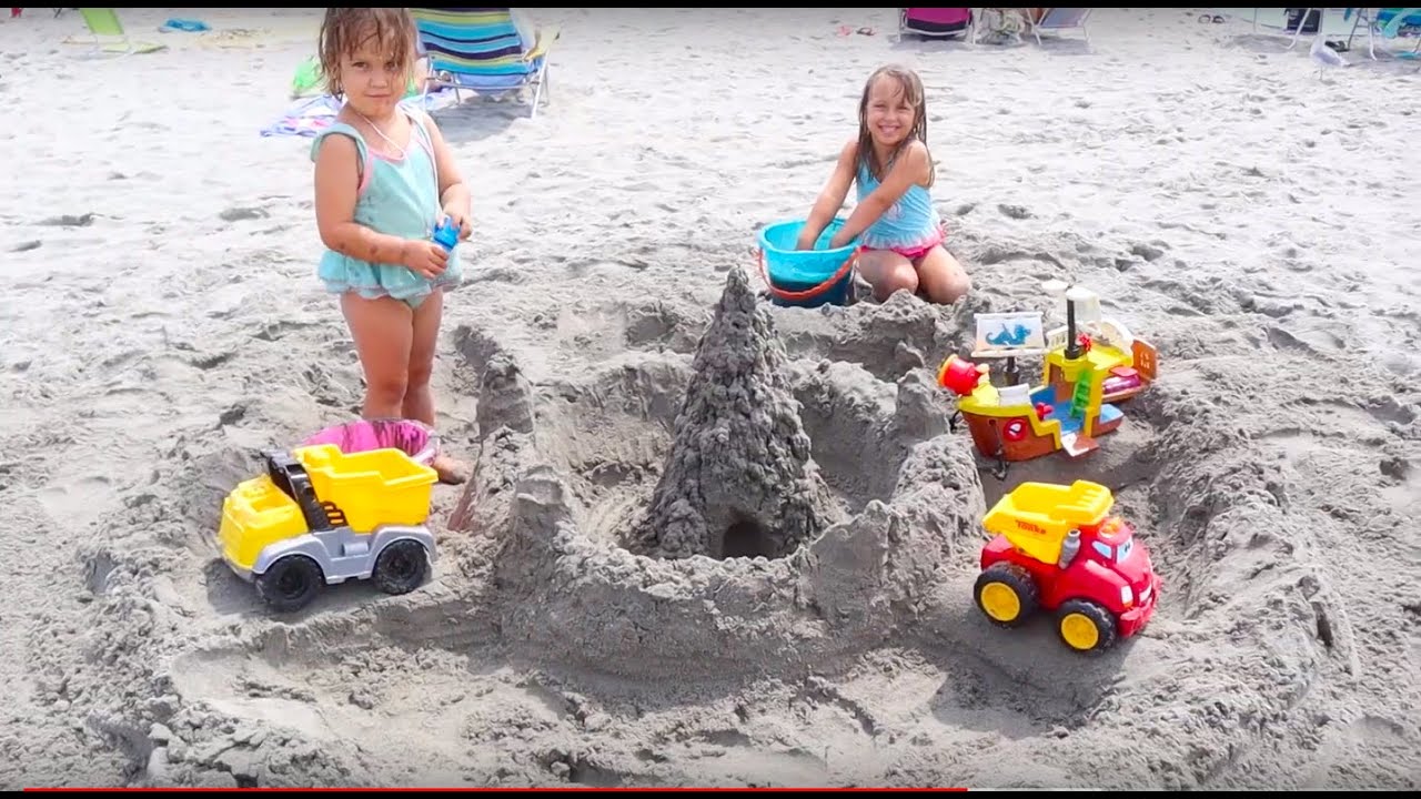 Kids playing on the beach. Making a HUGE sand castle.