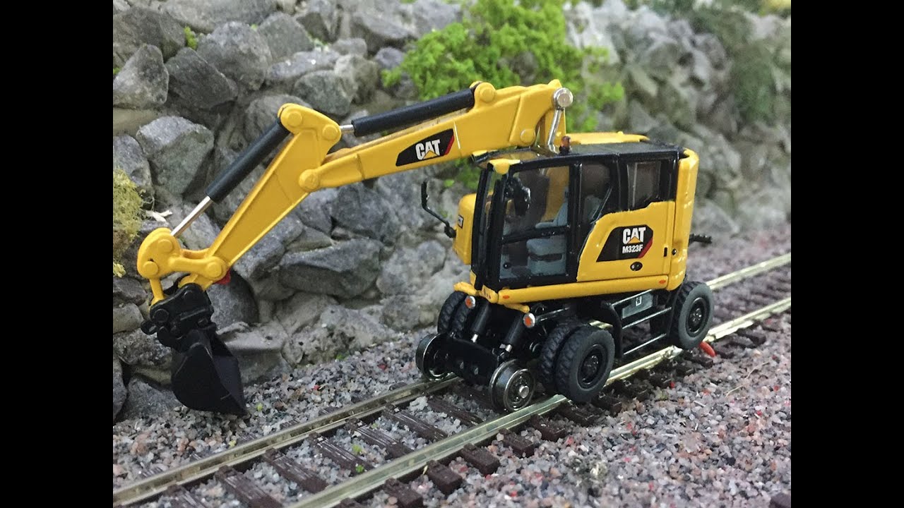 Produktpräsentation  Zweiwegebagger Eisenbahnbagger Gleisbagger Cat Caterpillar Diecast Masters - H0