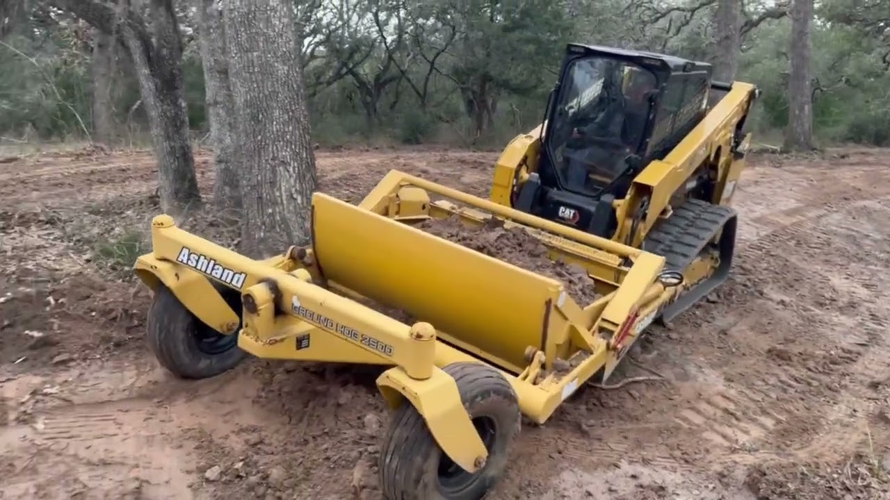 Caterpillar Skid Steer and Ashland scraper moving dirt