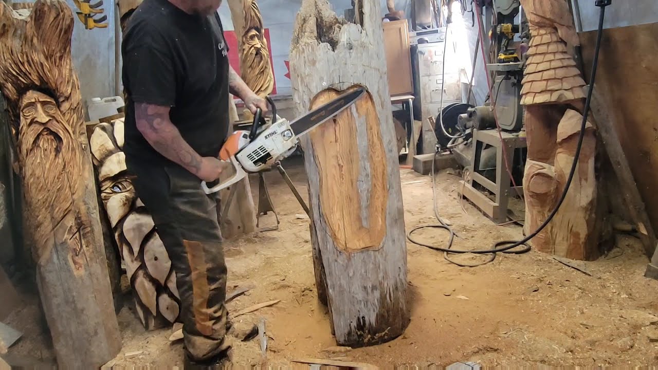Chainsaw carving driftwood owl in a nook.