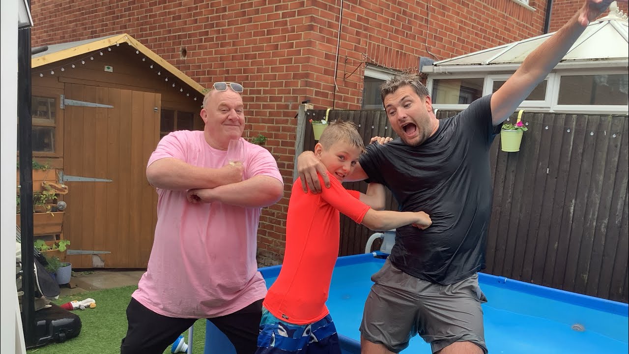Family swimming pool wrestling match