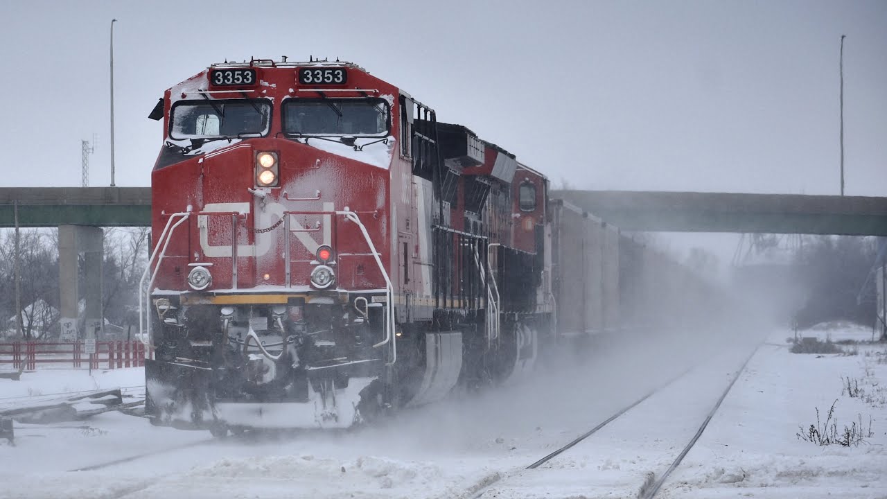 Amtrak and two CN trains kick some snow up at Centralia IL