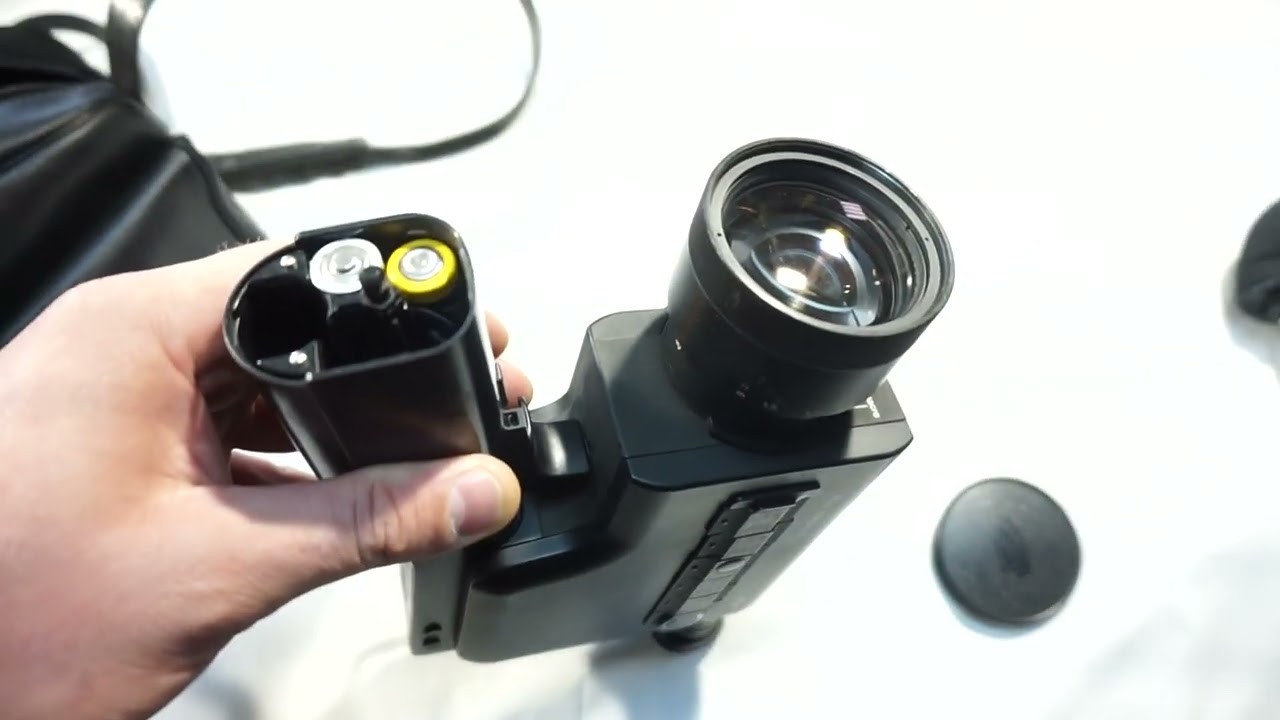 Nizo Integral 7 loading Super 8 film and batteries on Super 8 camera Braun Nizo Integral 7