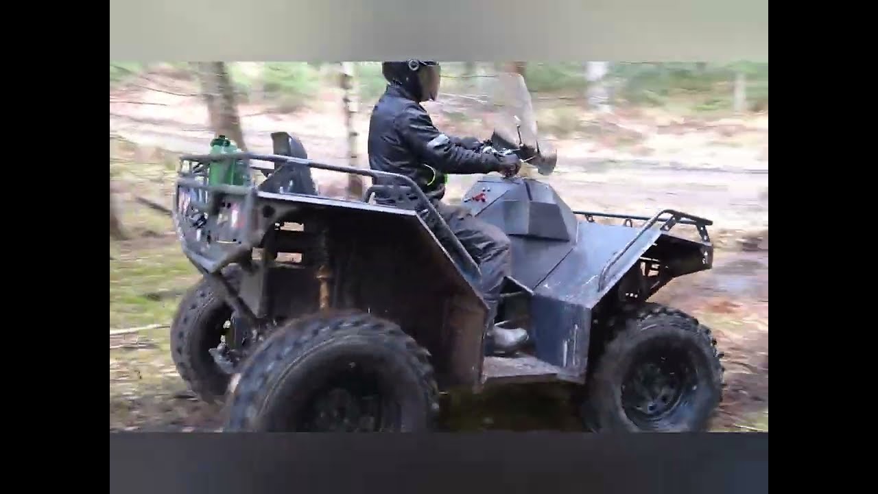 Homemade 4x4 atv riding in mud forest.