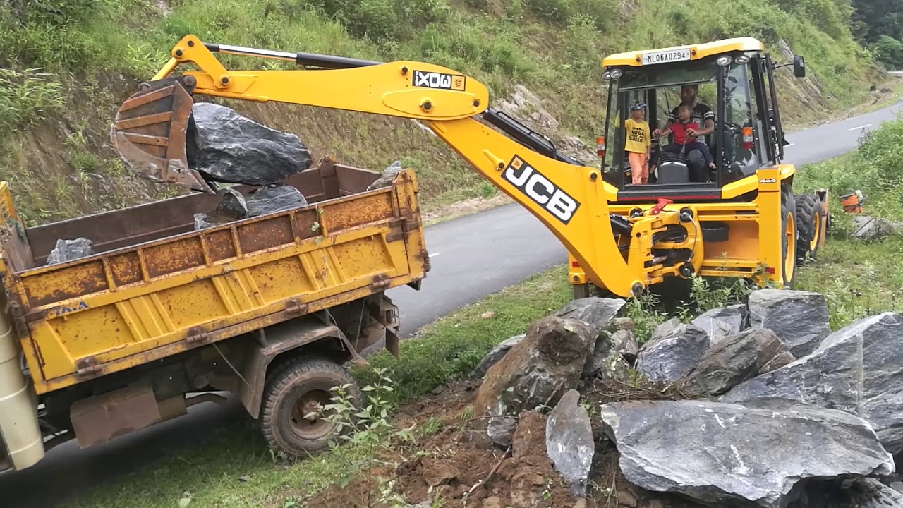 jcb 3dx super loading big stone## outside and inside view ## little boy operating jcb backhoe loader