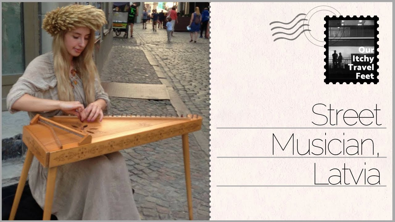 A street musician playing the kokle in Rīga town hall square. Latvia, 2016.