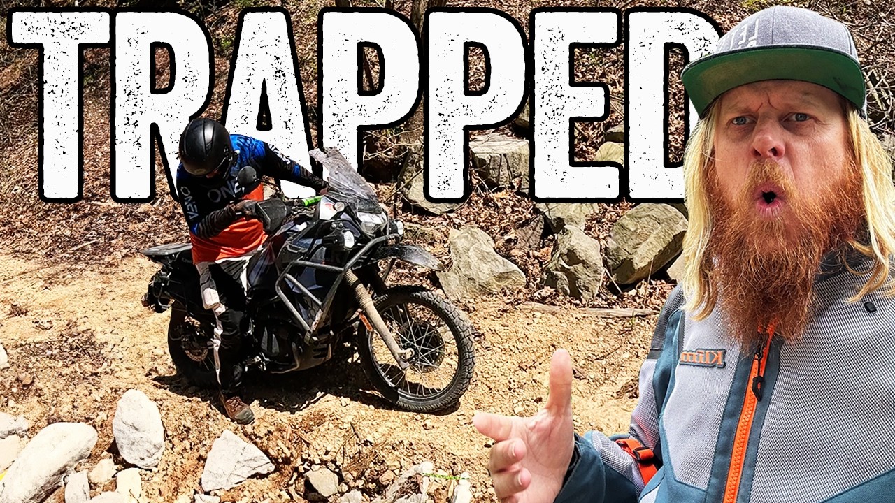 He falls and gets TRAPPED under the bike.