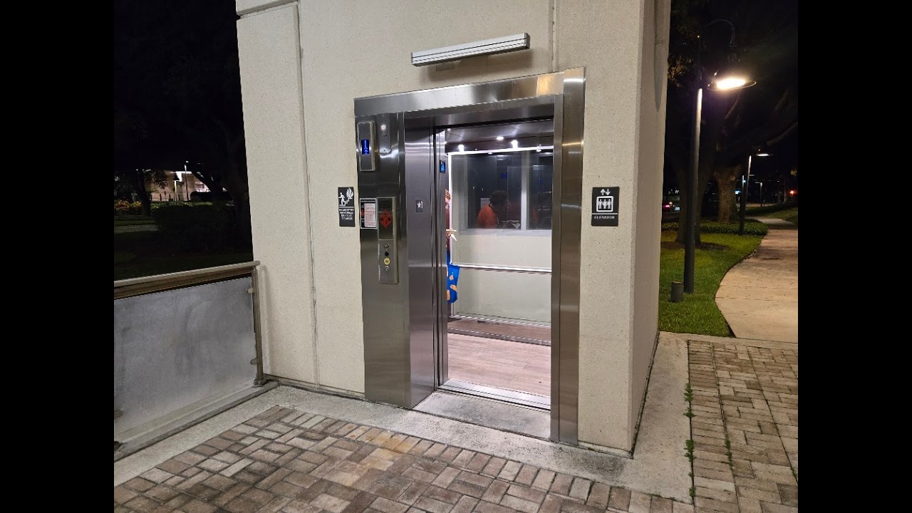 Orlando FL: Two Blue KONE EcoSpace Glass Elevators on a pedestrian bridge off International Drive