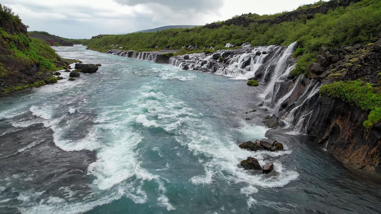 Flying in the rain at Hraunfossar Barnafoss Waterfalls in Iceland