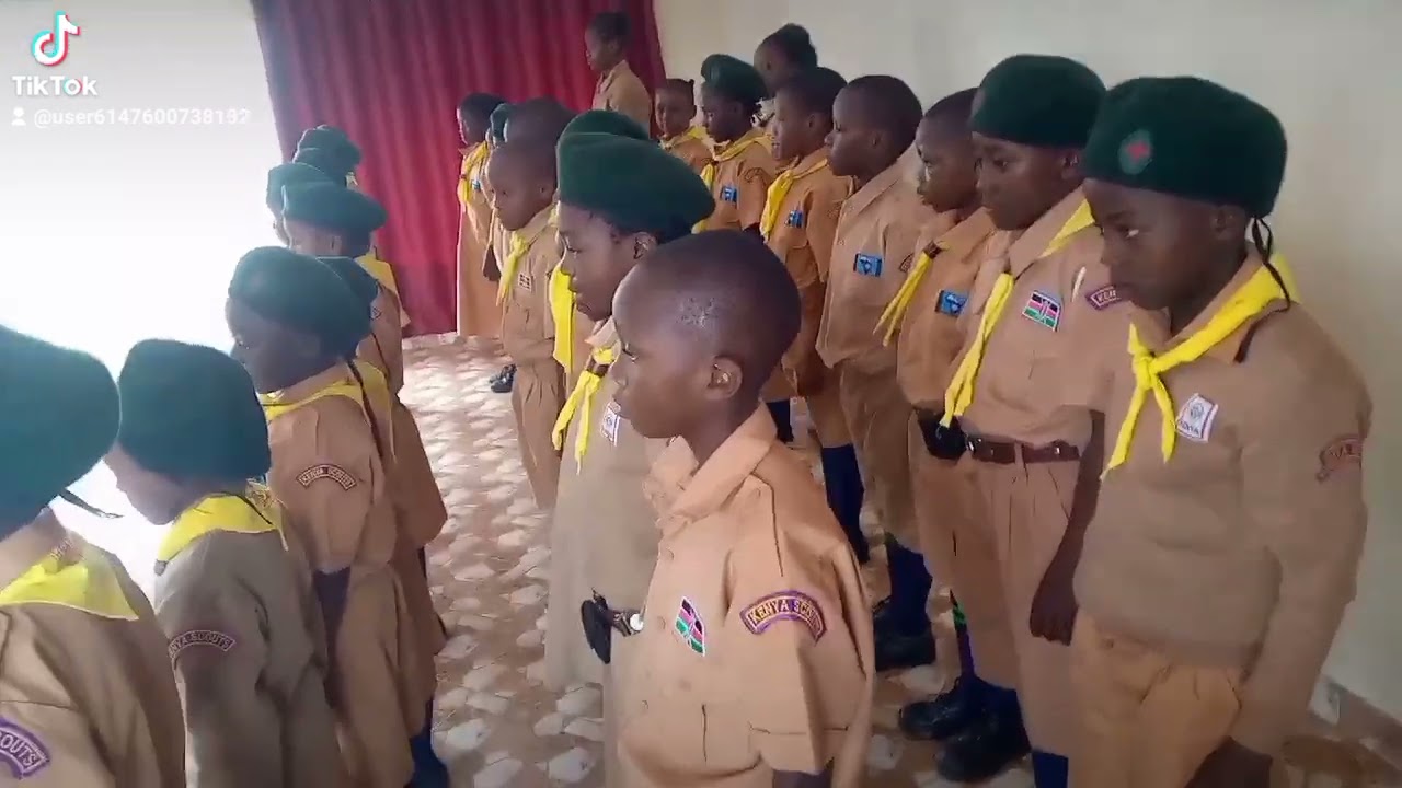 crossroad stars academy director inpecting the scout parade during the pp2 graduation 2022.