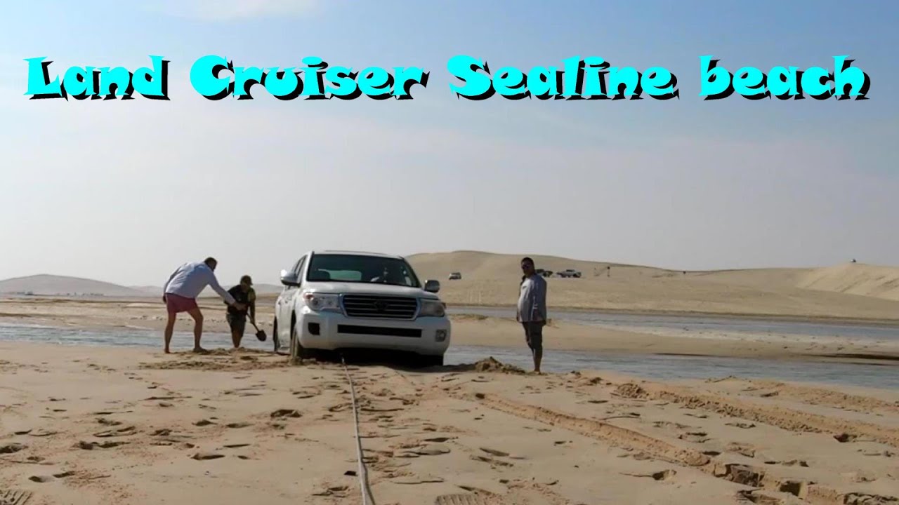 Toyota Land Cruiser stuck on Sealine Beach.