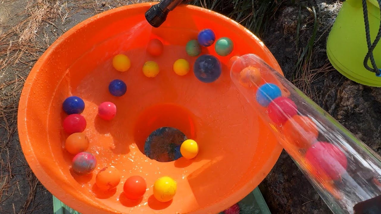 Make a water marble run course using transparent pipes and a large funnel. (Long rotating course)