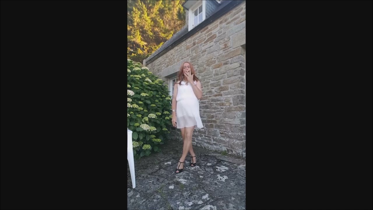 Crossdresser smoking in with pleated dress