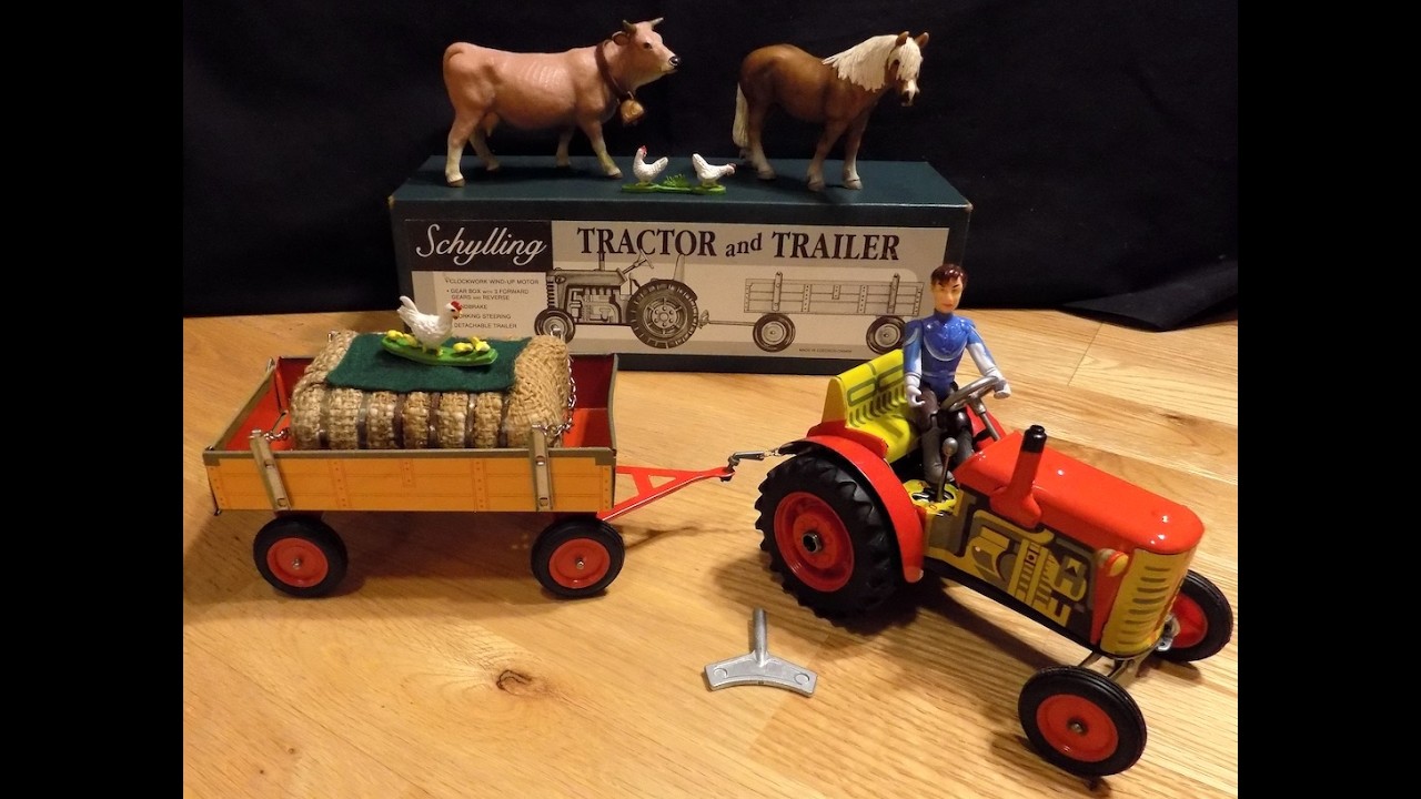 Tin toy tractor and trailer with farm scene