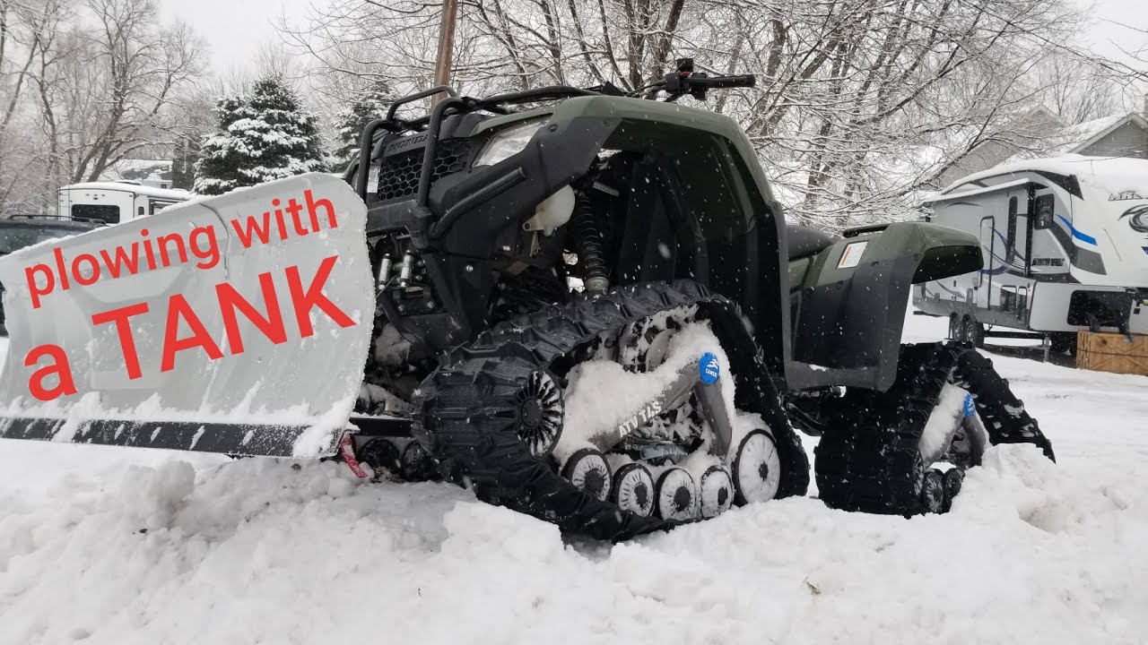 ATV with TRACKS plowing snow