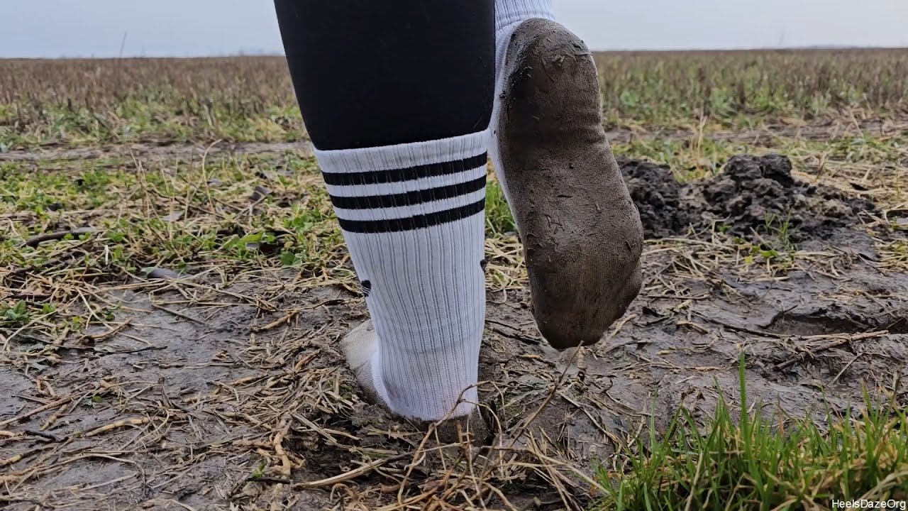 Walking on Muddy Field in White Socks Preview