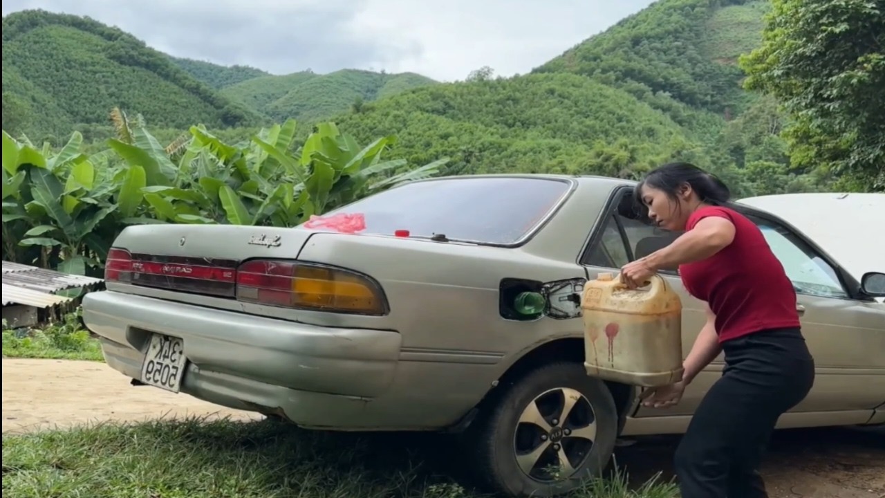 Skillful girl cleaning and repairing abandoned dirty car