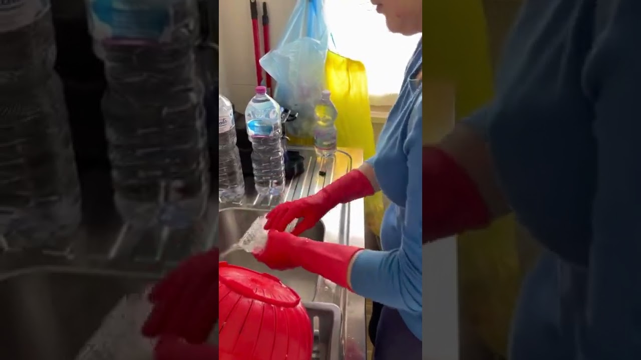Washing the dishes in rubber gloves and rain boots