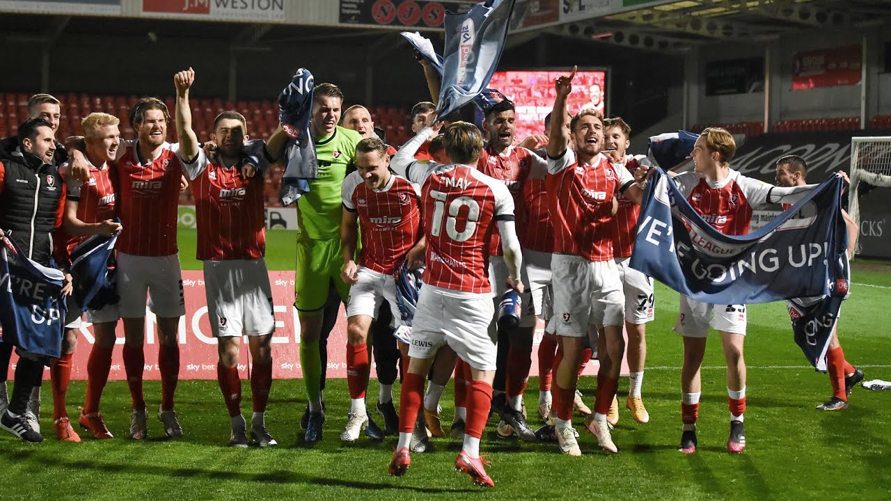Players and fans celebrate Cheltenham's promotion to League One