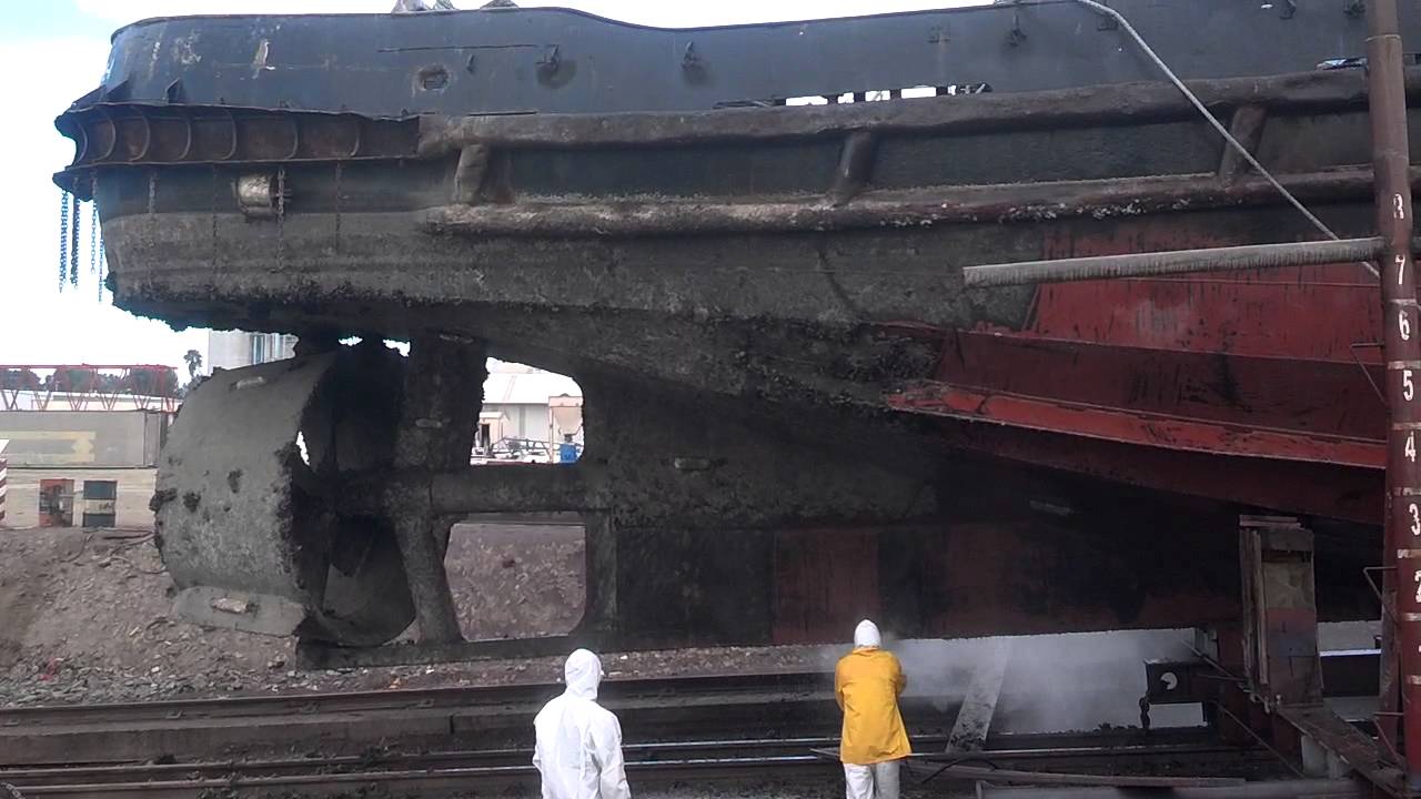 High pressure washing the hull of a tug boat