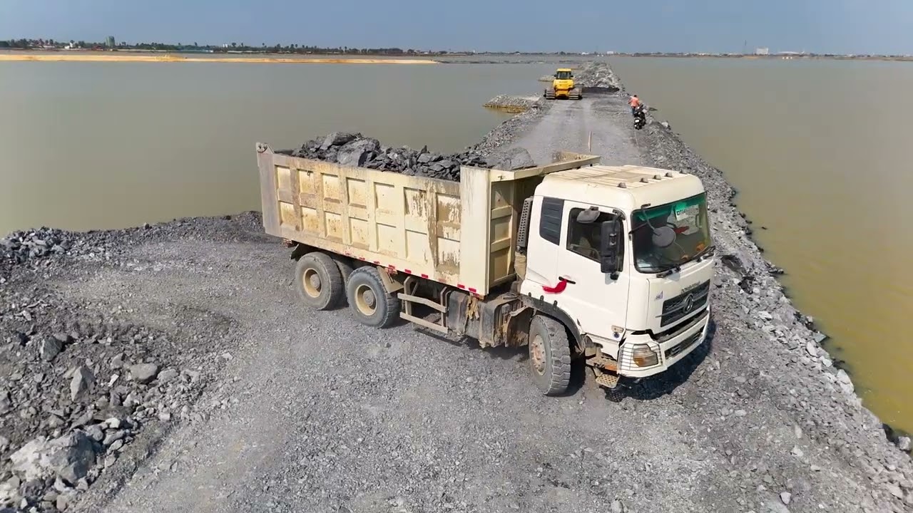 EP05,Fantastic road project Use a truck,wheel loaderand a Dozer Shantui to dump rocks into a sizabl
