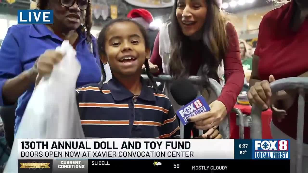 Fox 8's Lucy Bustamante and Nicondra Norwood share the joy at the T-P Doll and Toy Fund gift give...