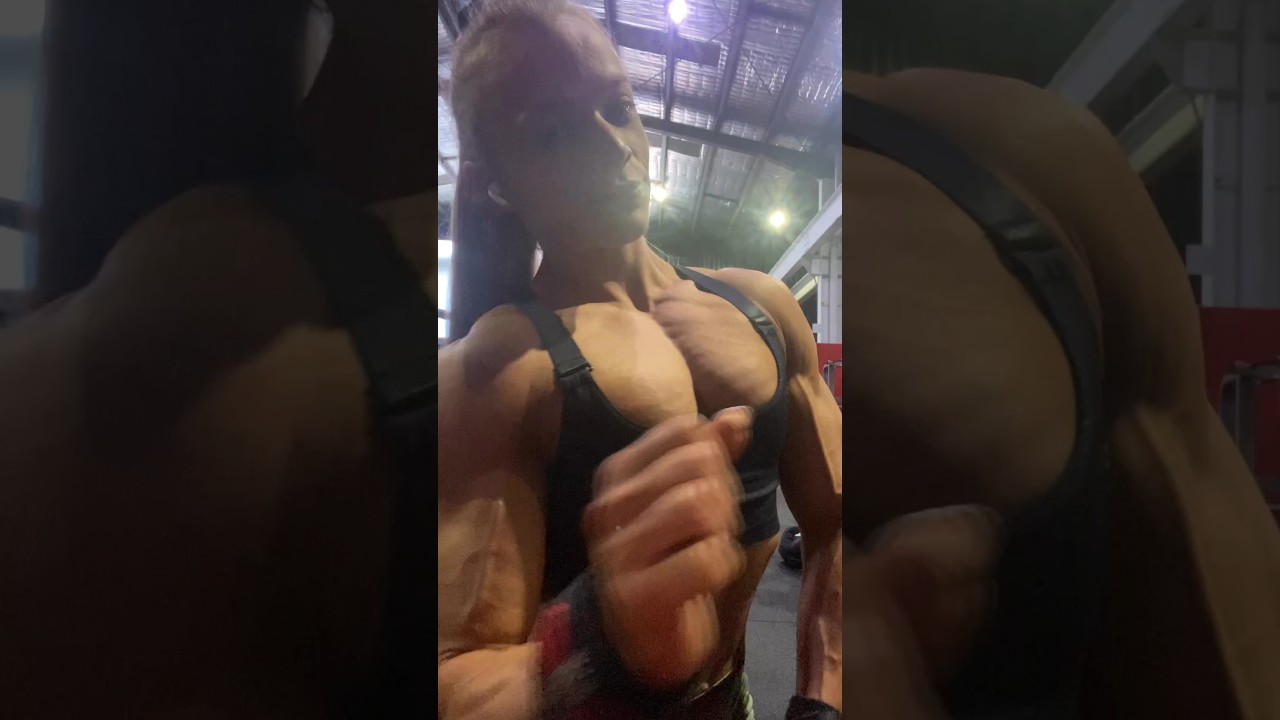 Sexy female bodybuilder's muscular arms and pecs flexing - Sarah Crail