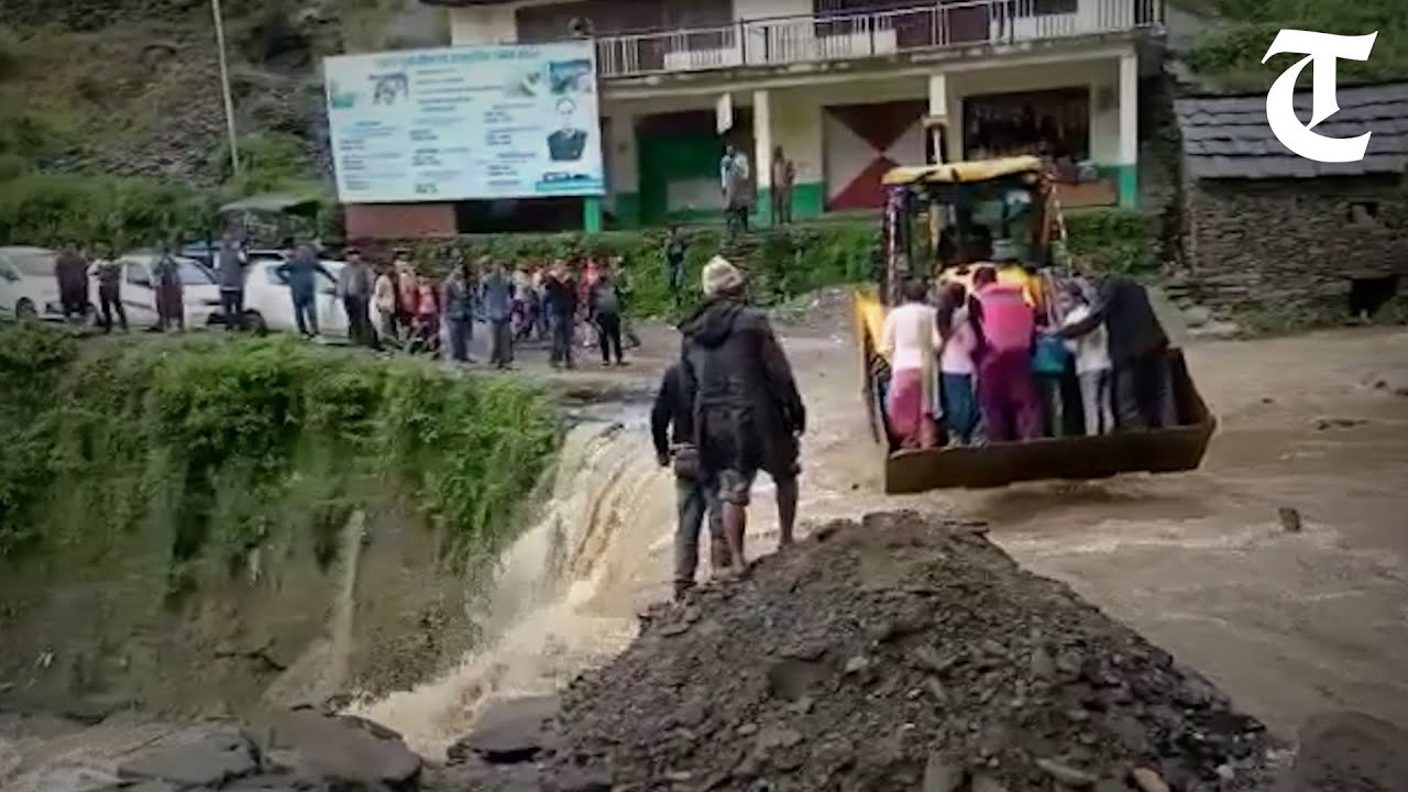 Mandi residents compelled to cross Shikha khud on JCB as proposed bridge project remains pending.