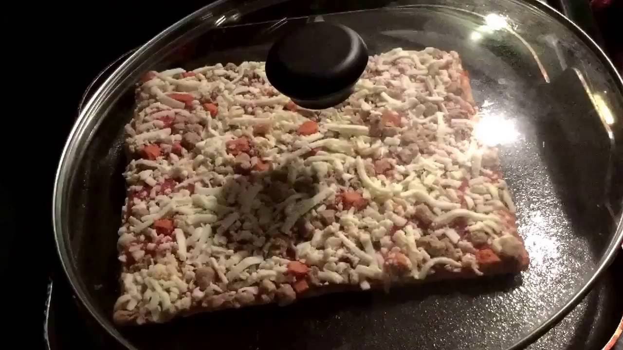 Cooking A Pizza On The Stovetop.
