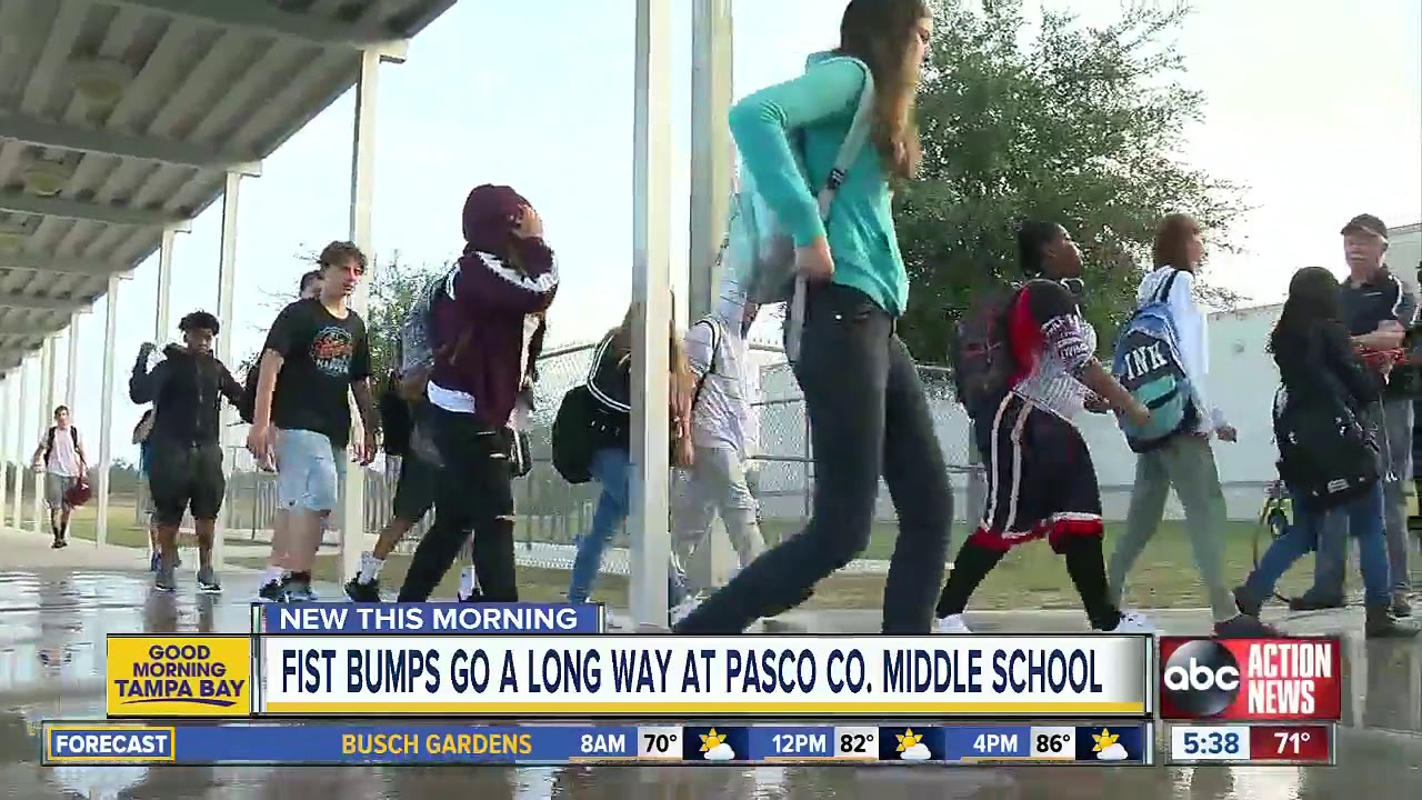 Two Pasco Co. school employees help kids get their day started on a positive note with a fist bump