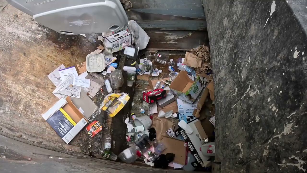Garbage truck hopper POV: McNeilus ZR on recycling