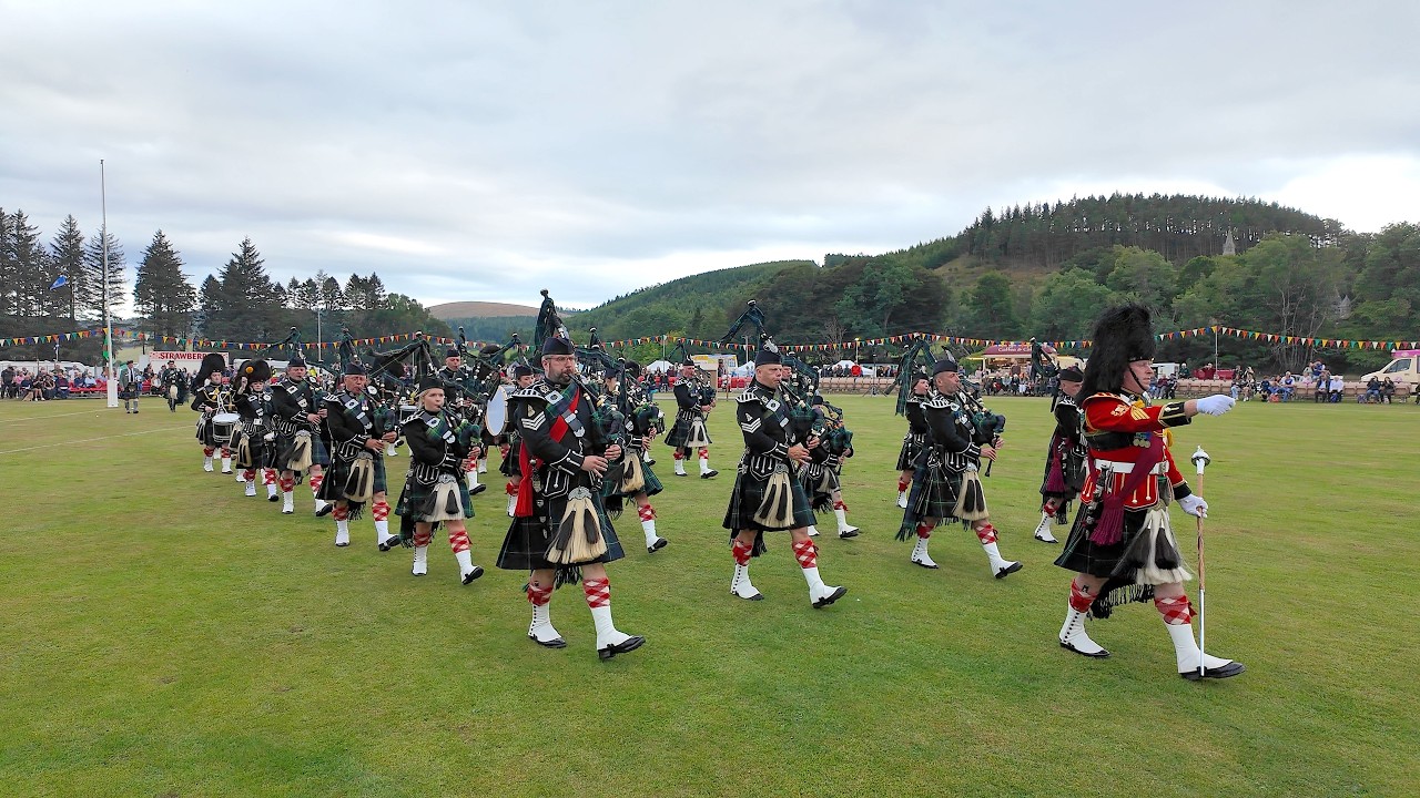 Lonach Pipe Band march out ending 2025 Lonach Gathering Highland Games Beating Retreat in Scotland