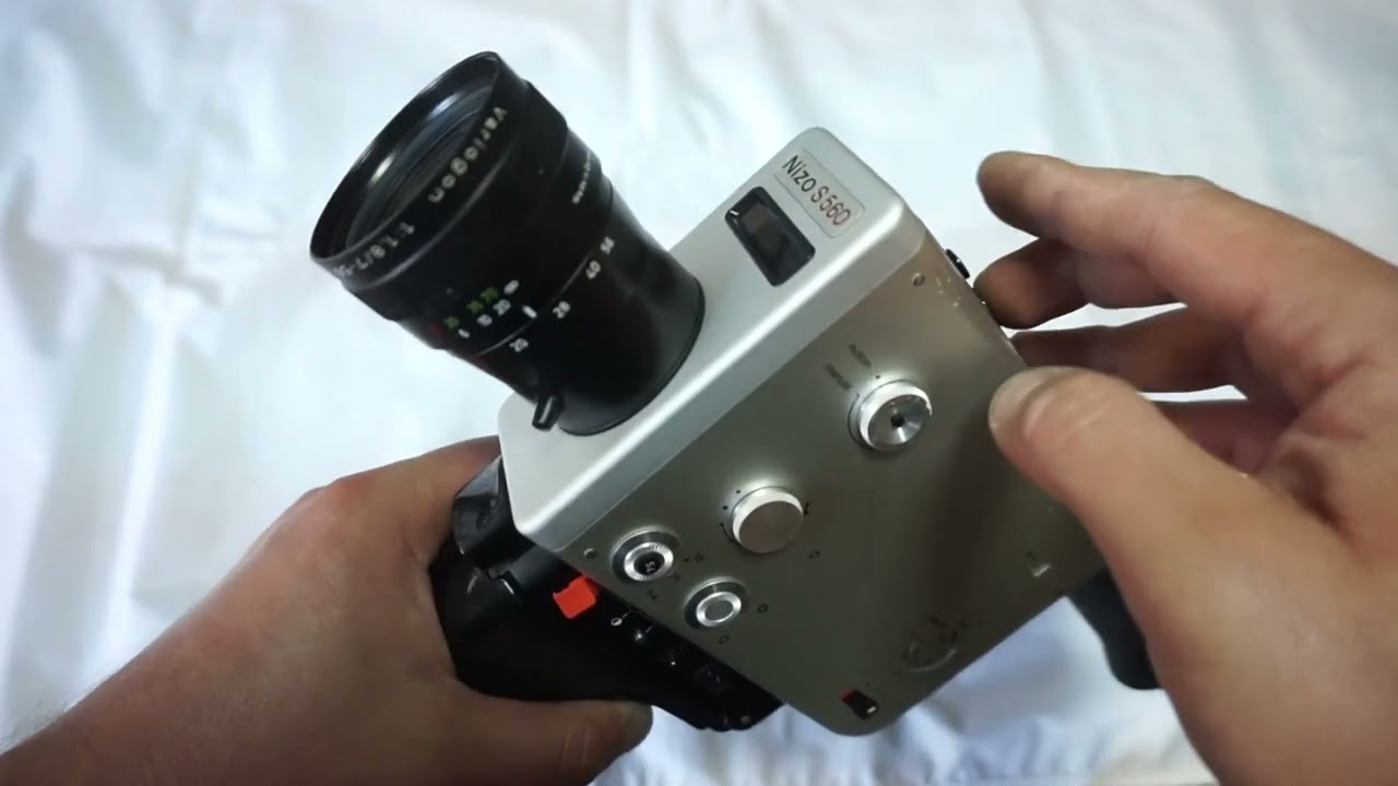Braun Nizo S 560 loading Super 8 film and batteries on Super 8 camera Braun Nizo S560 super 8 camera